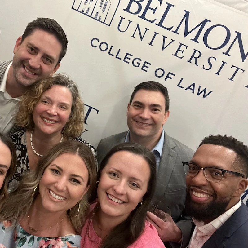 Law alumni selfie in front of step and repeat