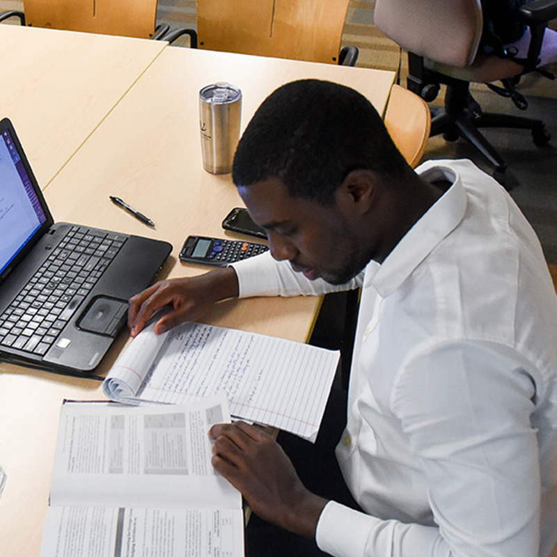 Adult student studying on laptop