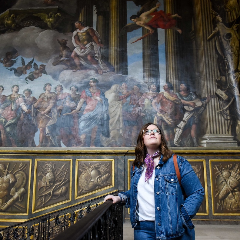 Student looking at art of the walls of a building in London