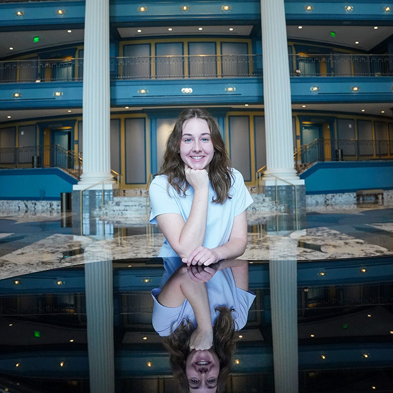 Olivia Hobbs standing at a piano in the Fisher Center for the Performing Arts