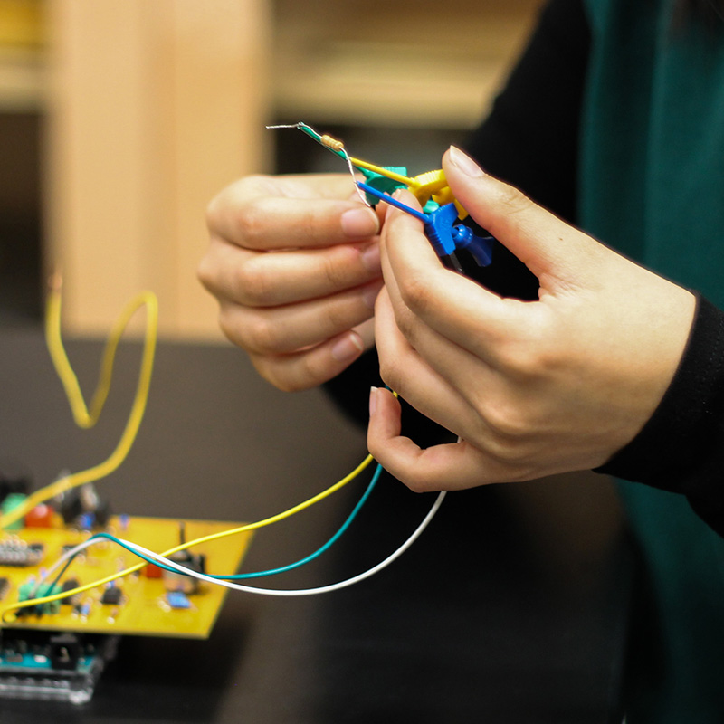 hands manipulating wires