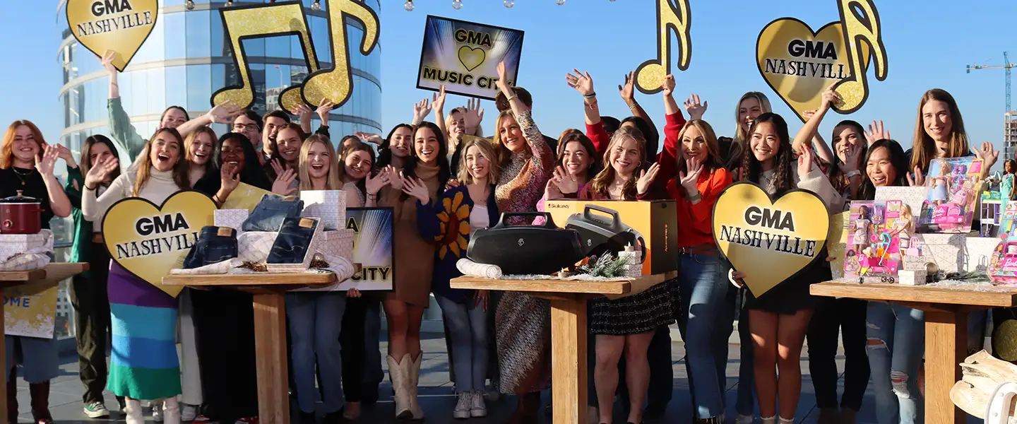 A group of Belmont Students cheering in the background of Good Morning America