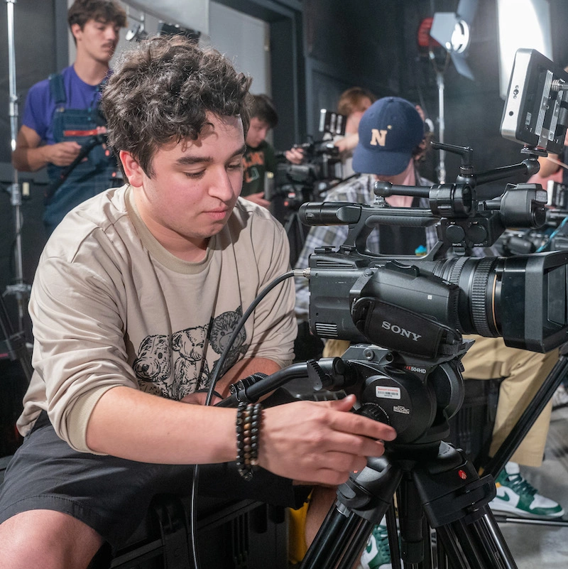 Male student lining up camera