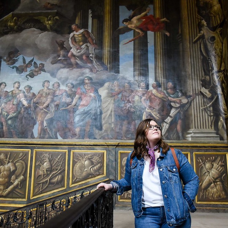 Student looking at art on walls in London