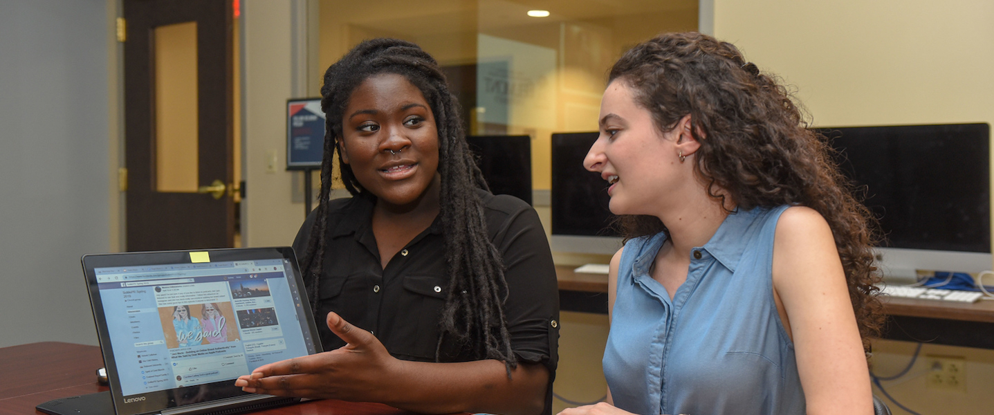 two students working on a computer