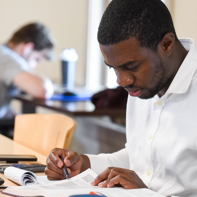 Close up of student studying their books in a study room