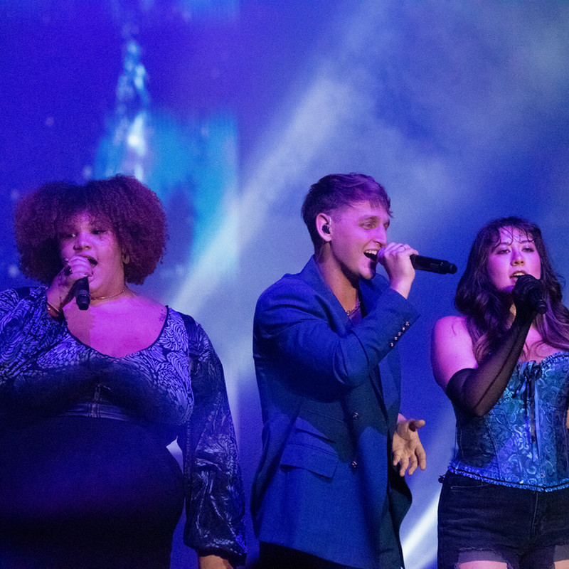 a trio of musicians singing