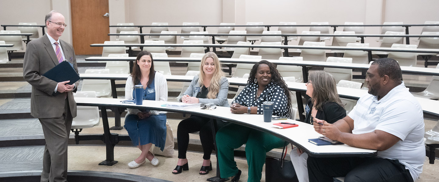 professionals talk in an academic setting