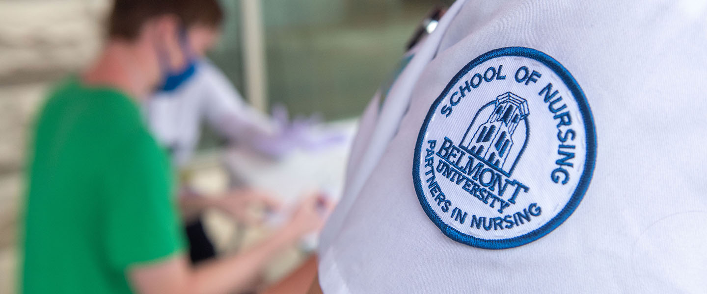 The shoulder of a Belmont graduate student showing the School of Nursing, Partners in Nursing logo