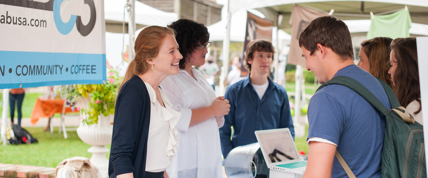 student entrepreneur talks about her business at a fair