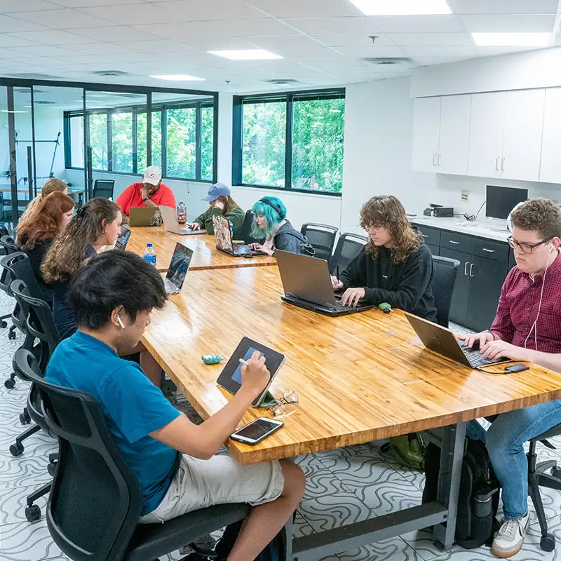 Students sitting around a table doing group work