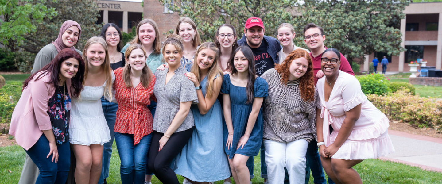 The 2022-2023 Belmont Ambassadors smile for a photo in front of the Bell Tower.