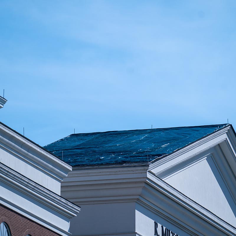 The roof of a building after storm damage being repaired