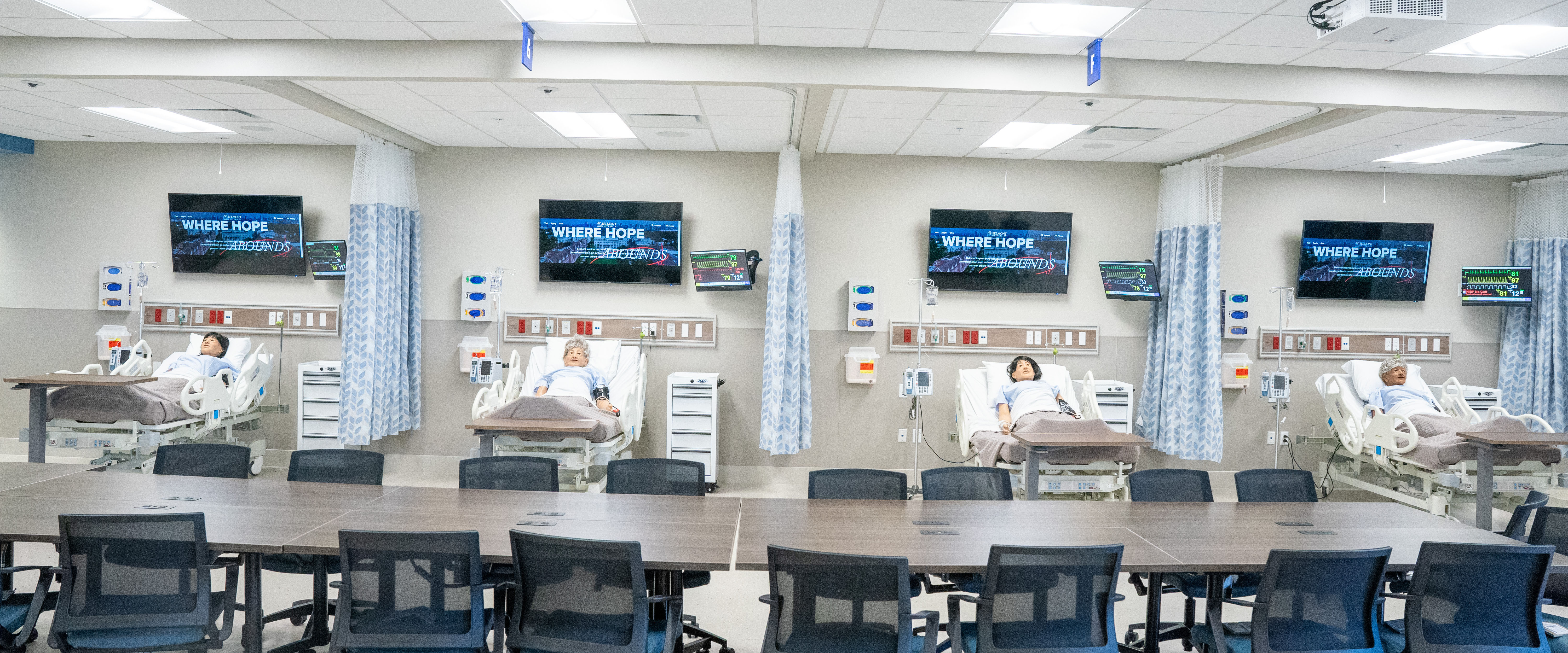 Empty simulation center with medical dummies in hospital beds