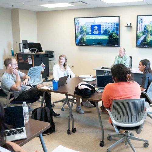 Students learning and having discussion in a classroom