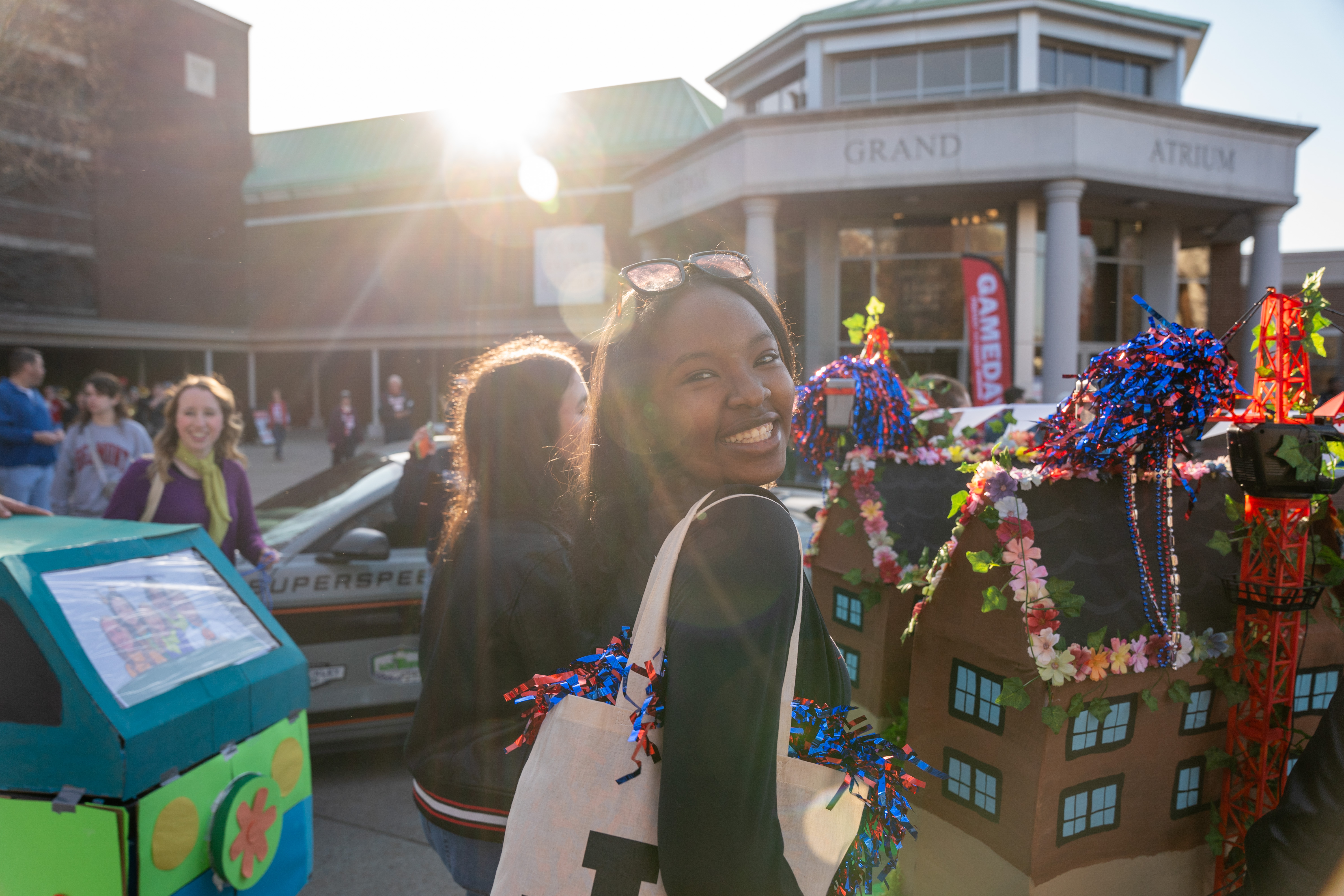 Student smiles at Homecoming Parade 2024