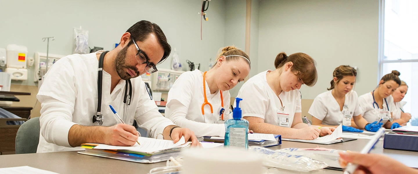 Nursing students working on a quiz while in class