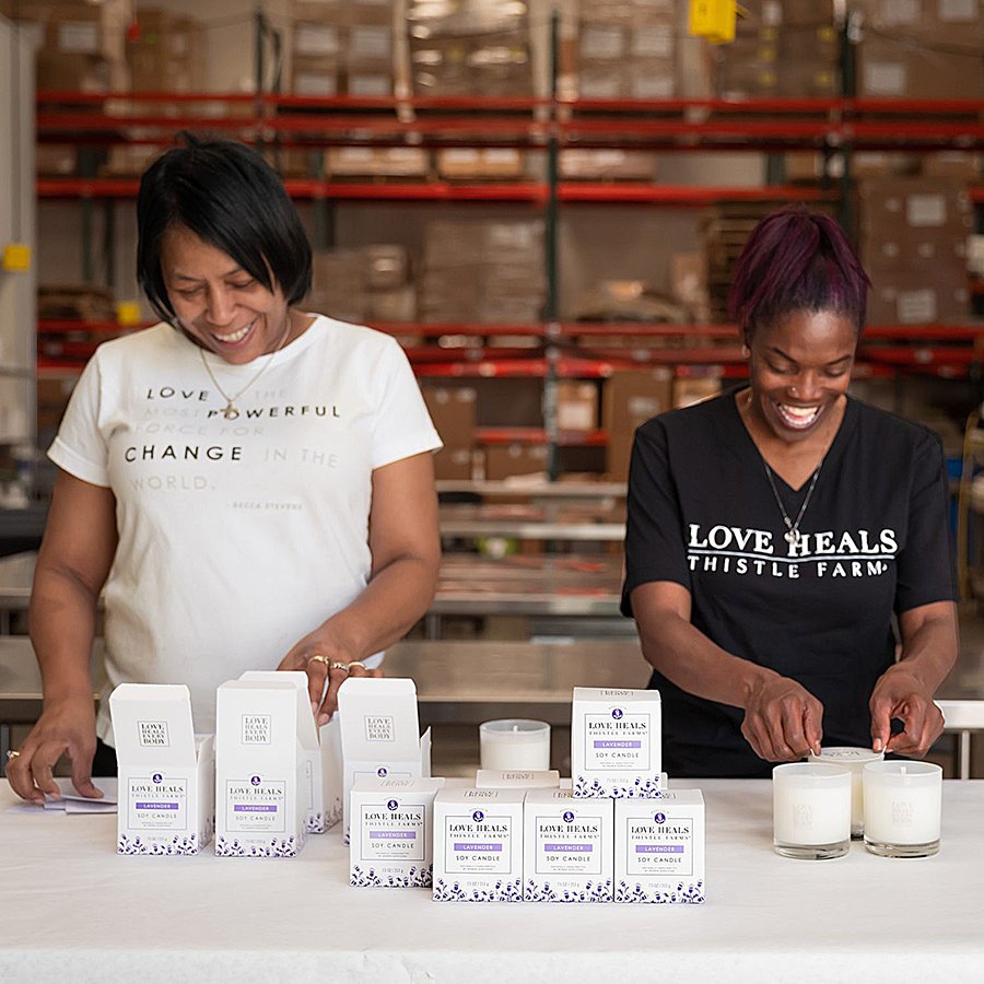 Two women working together to pack products on a table