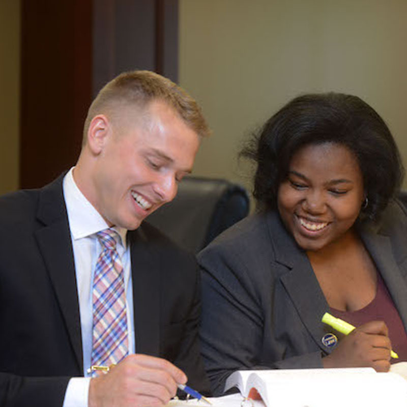 Two Students at Library Studying Smiling