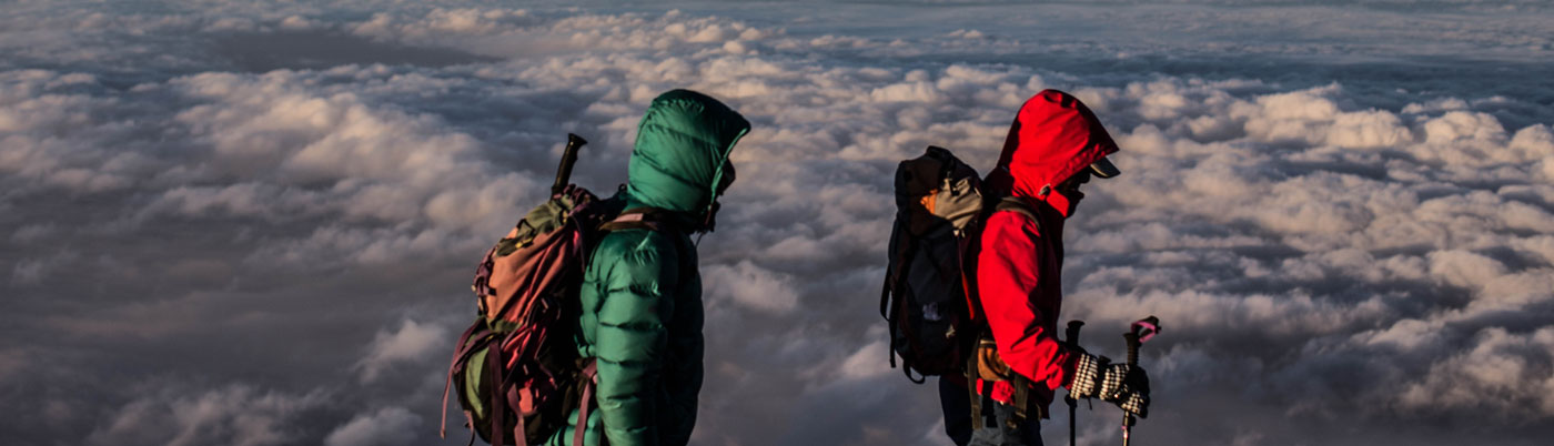 Two hikers walking through the mountains