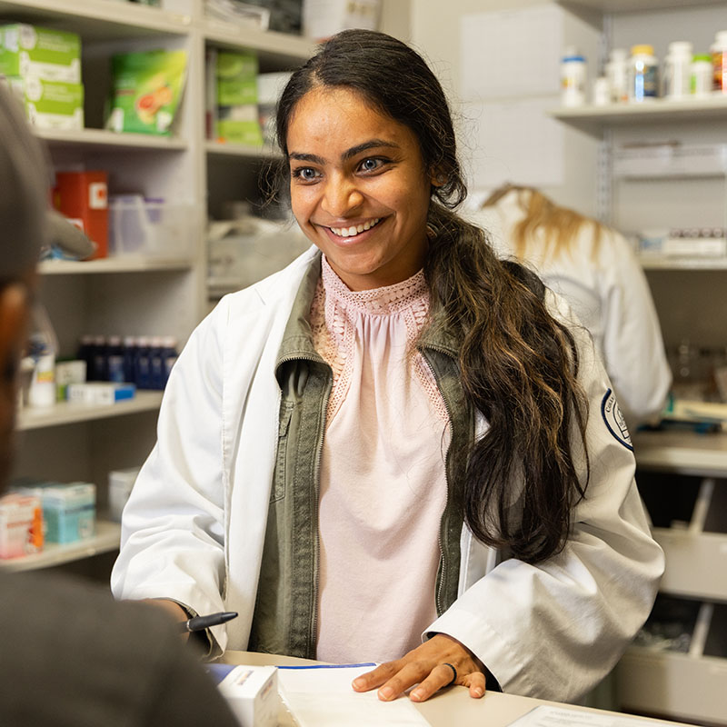 medical resident talks to a patient with a smile