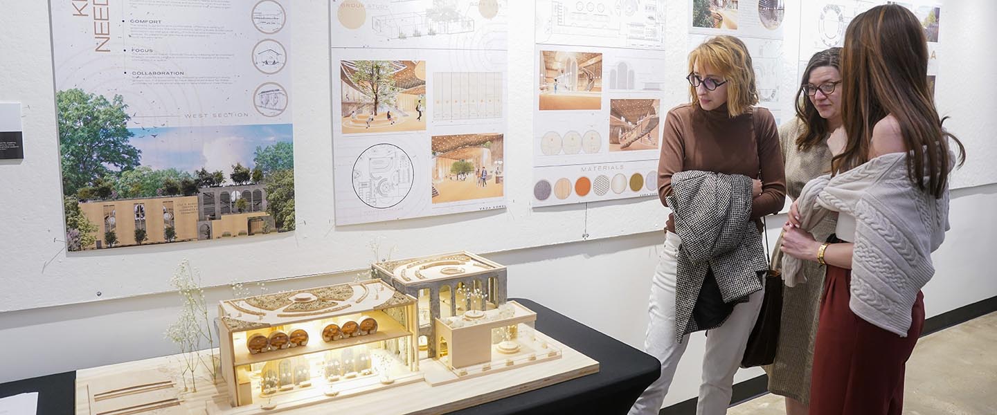 Group of women looking at building model design in hitch building