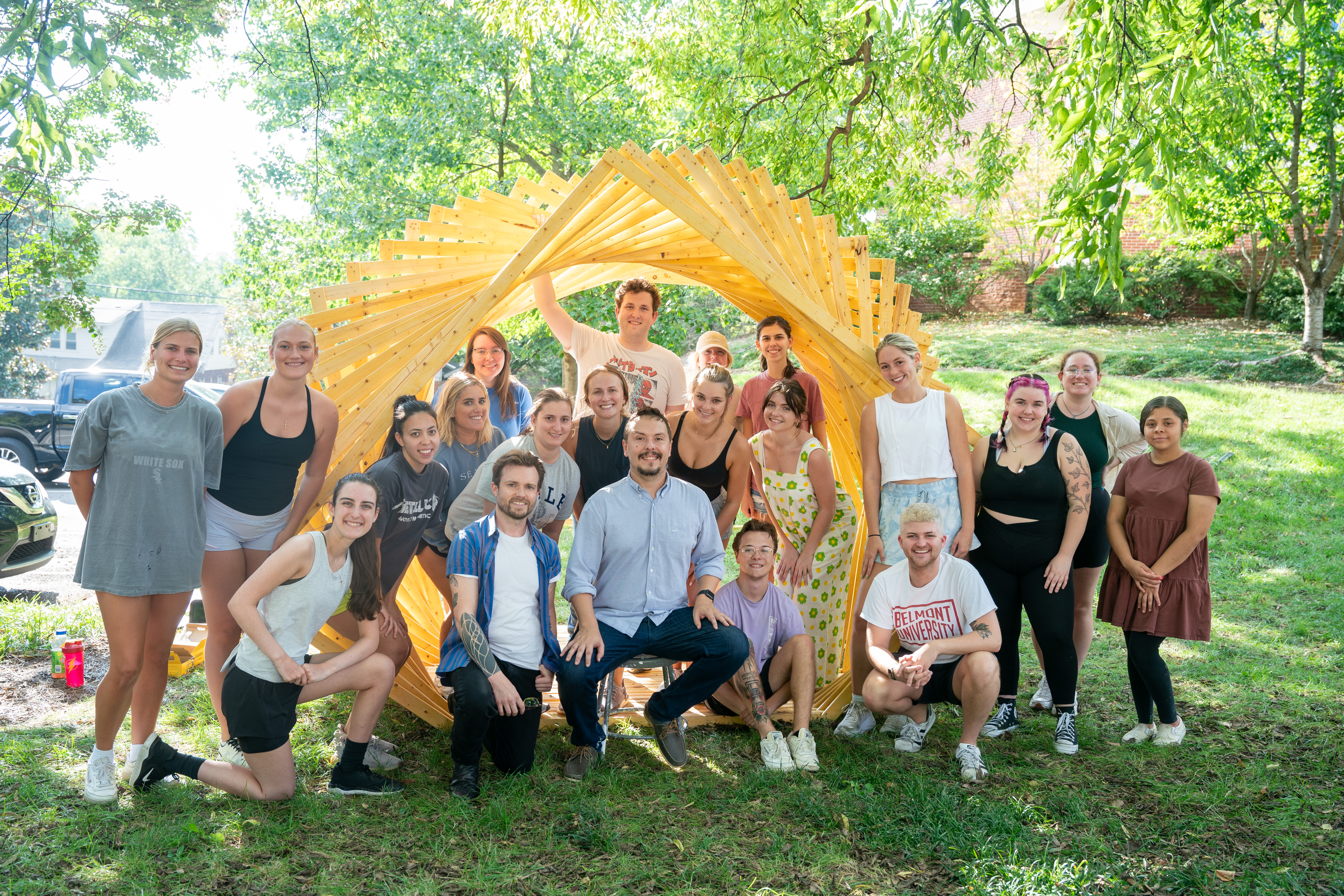 A group photo of the Fall 2023 Team in front of the Timber Twirl Installation