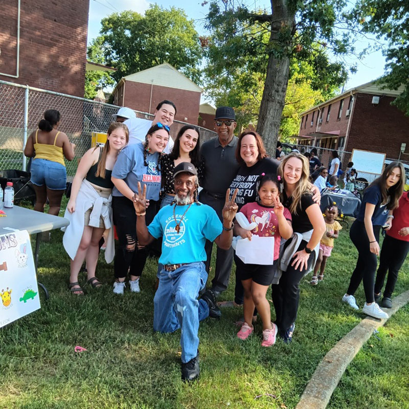 Group of people at community event smiling for the camera