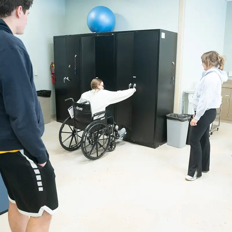 Students learning about wheel chair accessibility in class