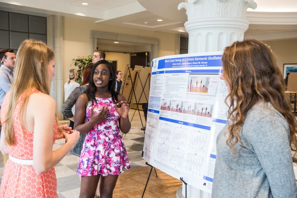 SURFS students giving their research presentation in the Ayers Atrium