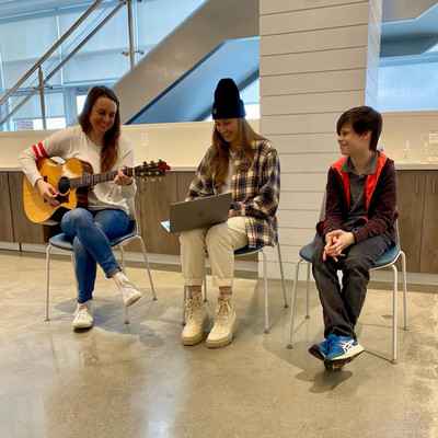 songwriters with poet finalist, all smiling