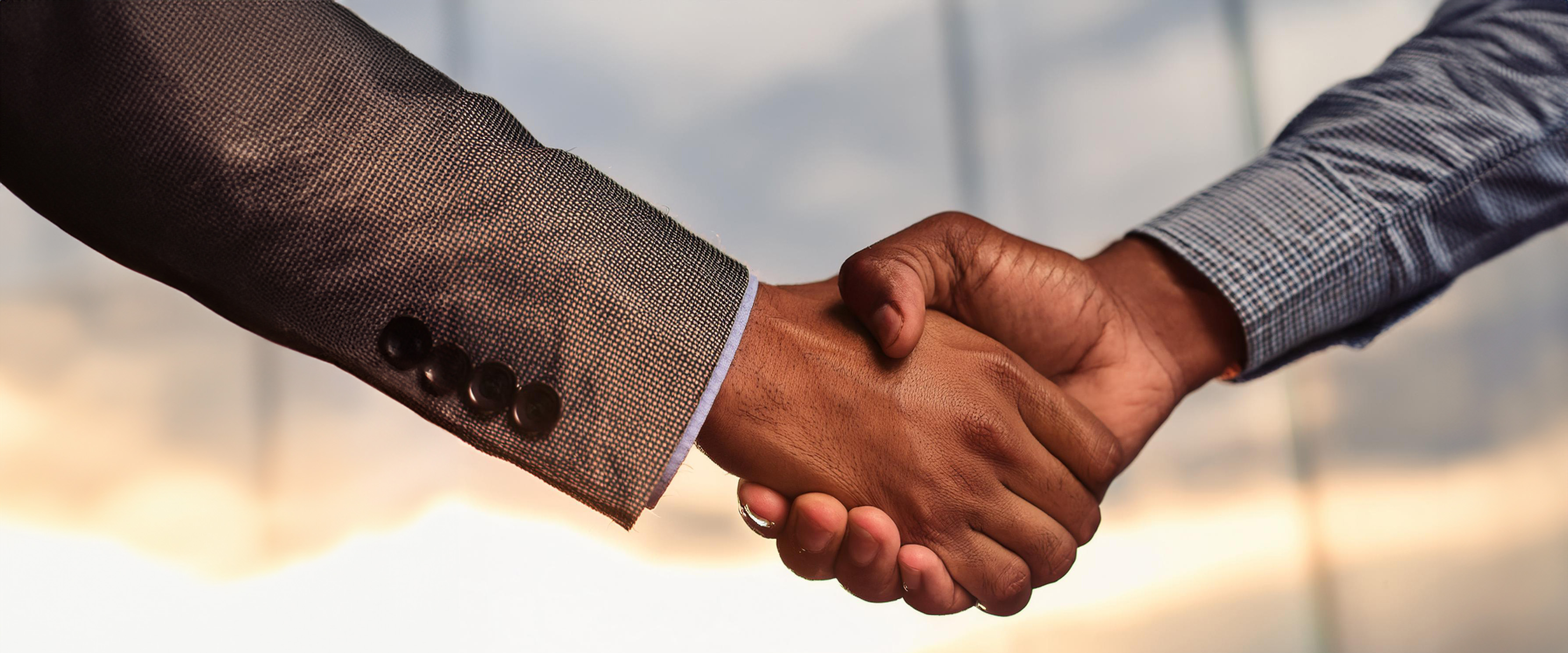 close up of 2 people shaking hands