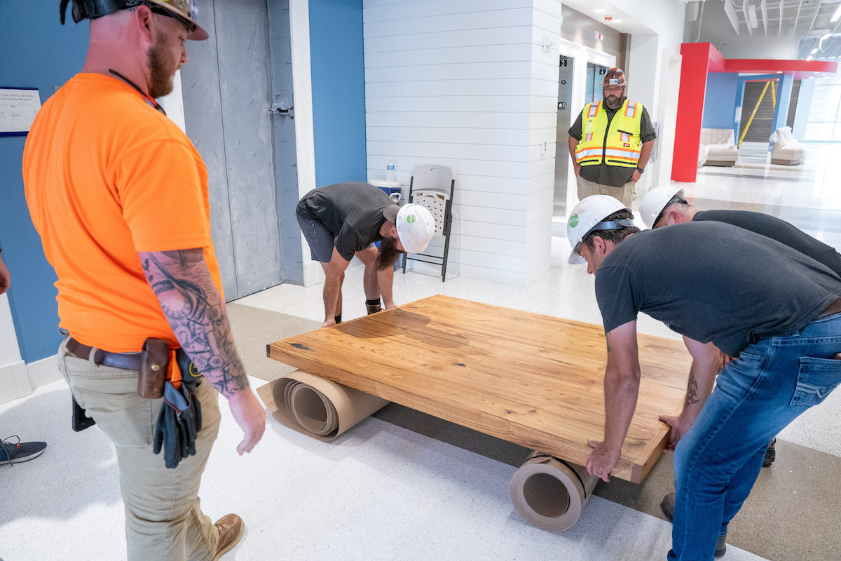 Moving piece of table into Massey Center.