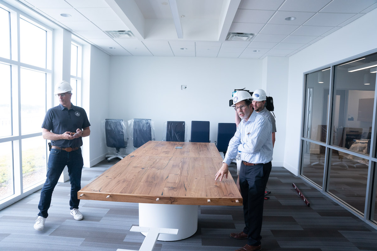 Dave Puncochar and David Minnigan in conference room with table.