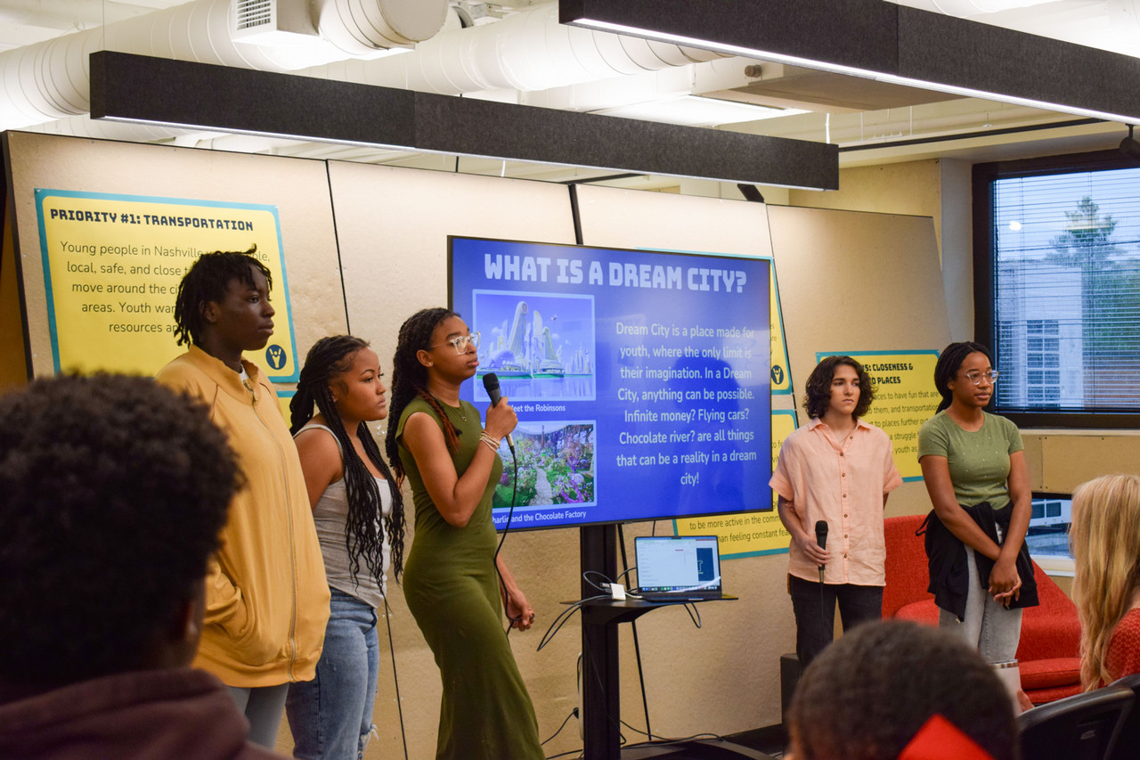 Five students from the Nashville Youth Design Team present in front of a screen