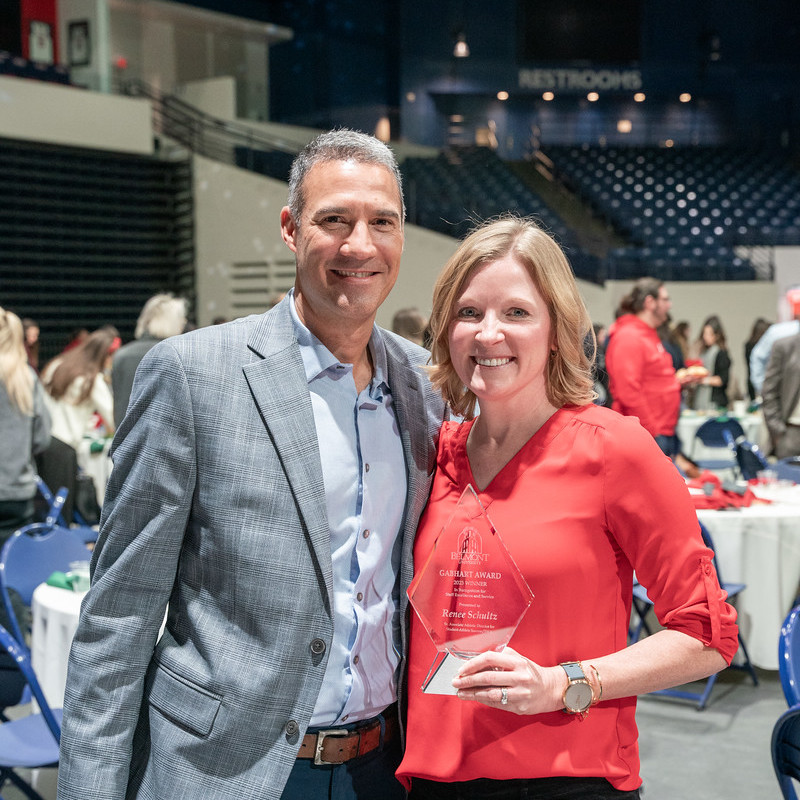 Renee and her husband with her award