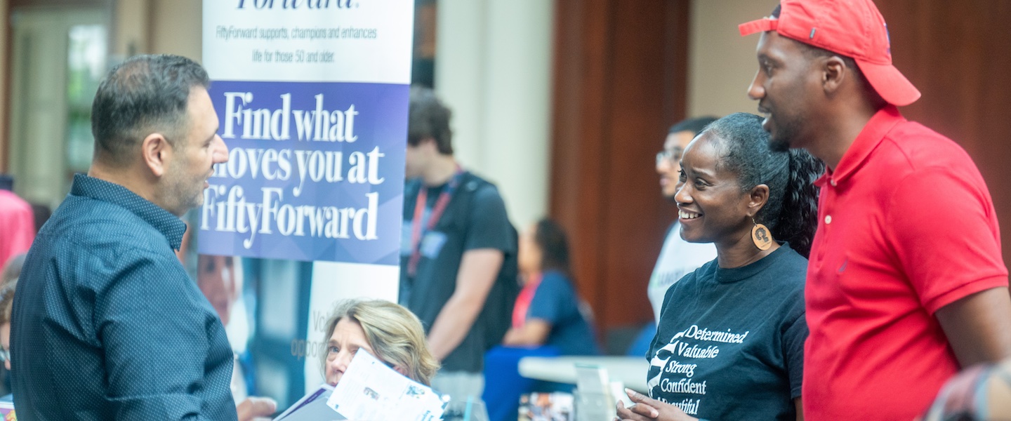 participants talk at the community connections fair