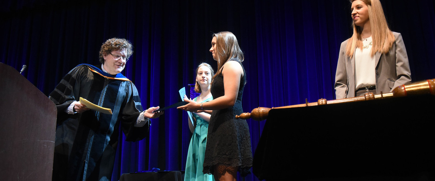 Sheyanne Smith receives diploma from Professor David Dark