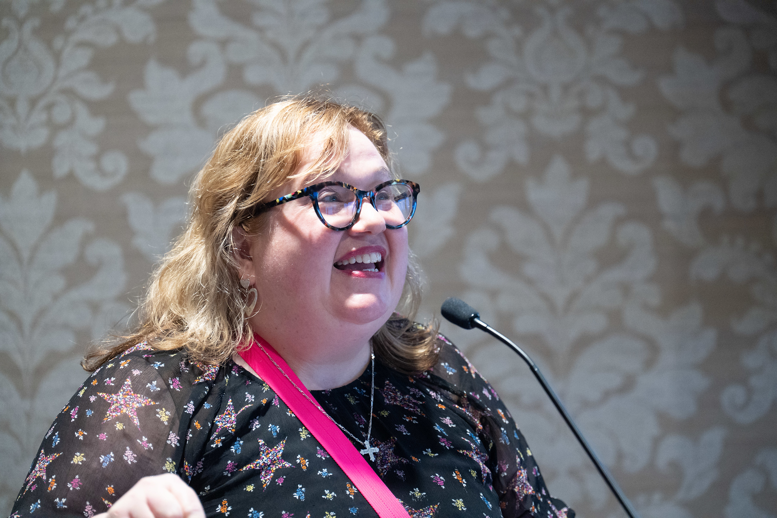 Dr. Bonnie Smith Whitehouse speaks into a microphone at a podium