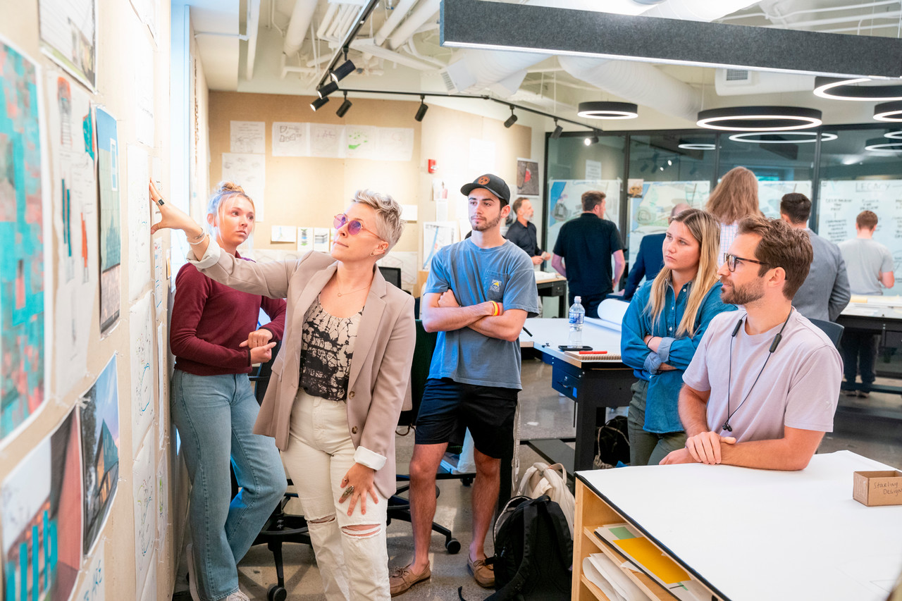 Student Kim Page Sullivan presents her team's project in a workshop with local design professionals