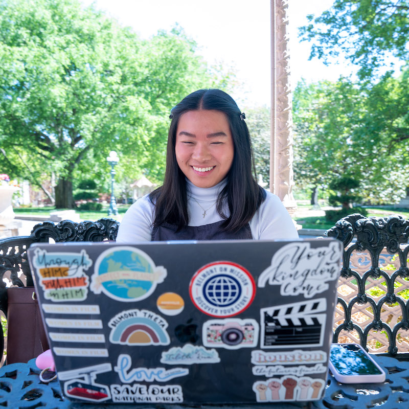 Student outside on laptop