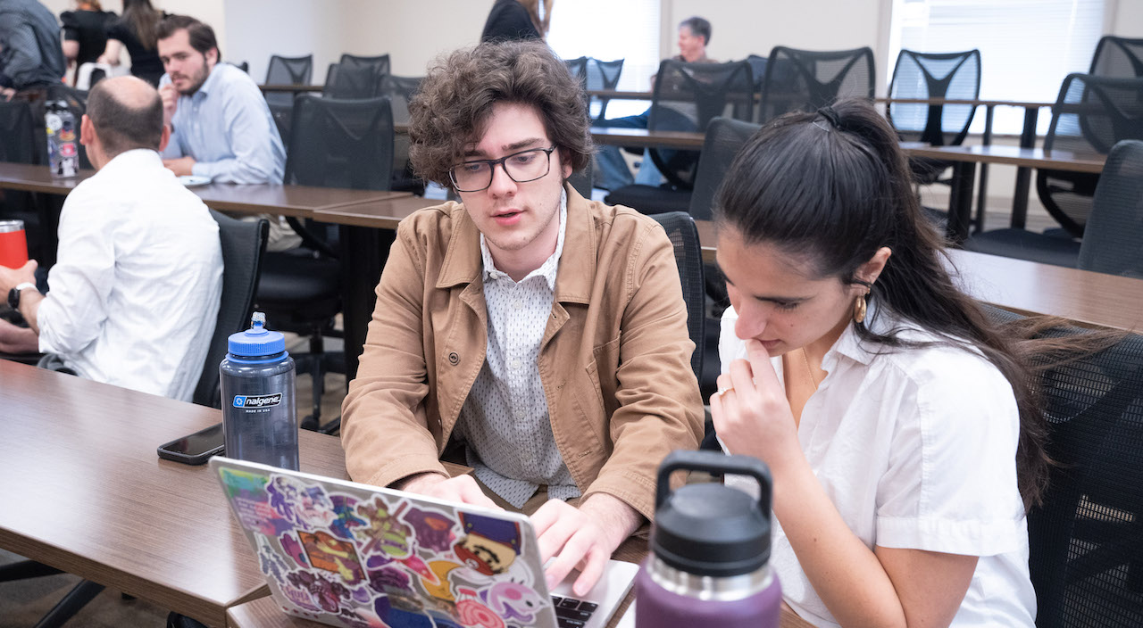 Global honors students converse in a classroom