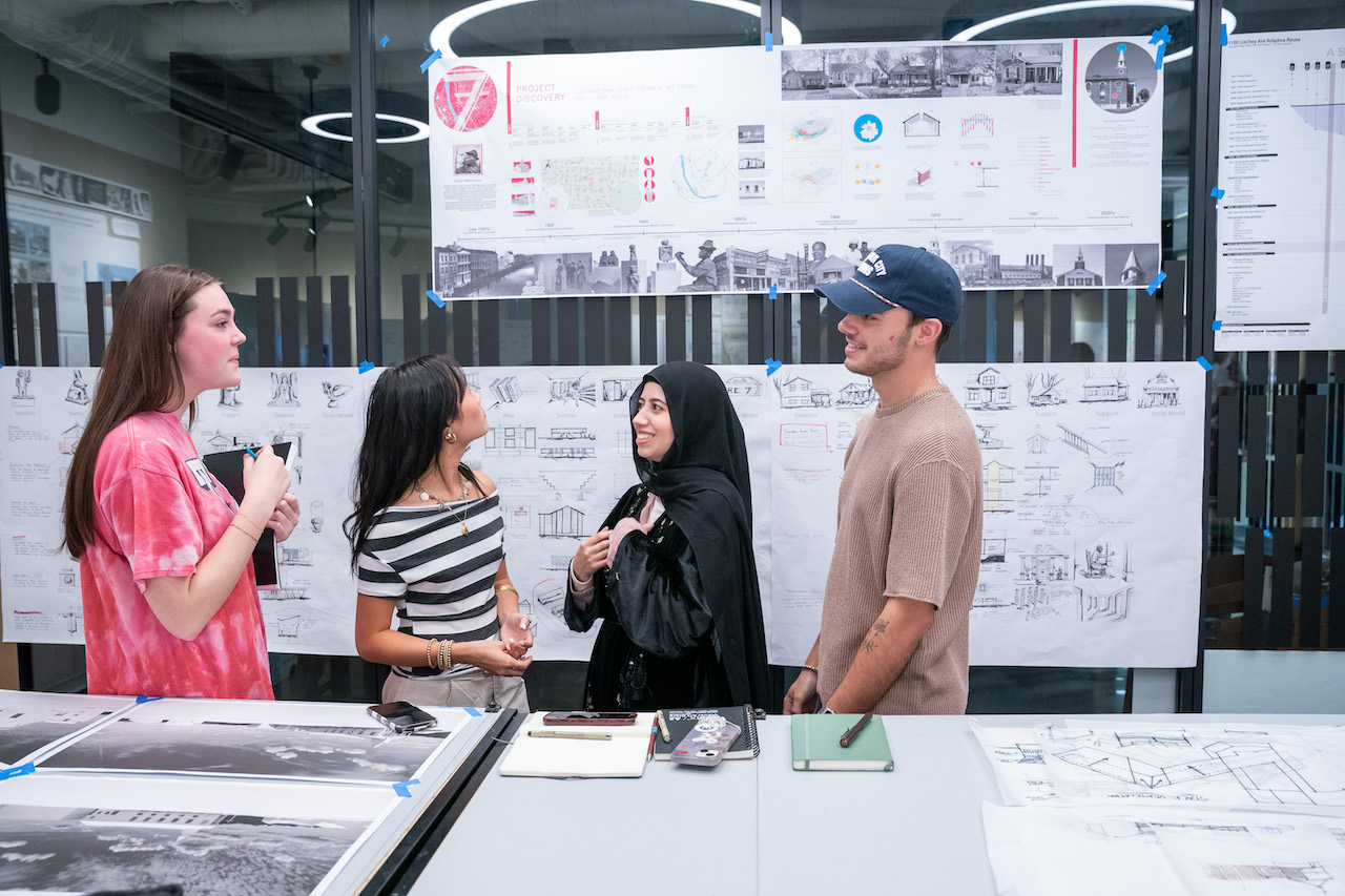 Four students working together on an interior design and architecture project