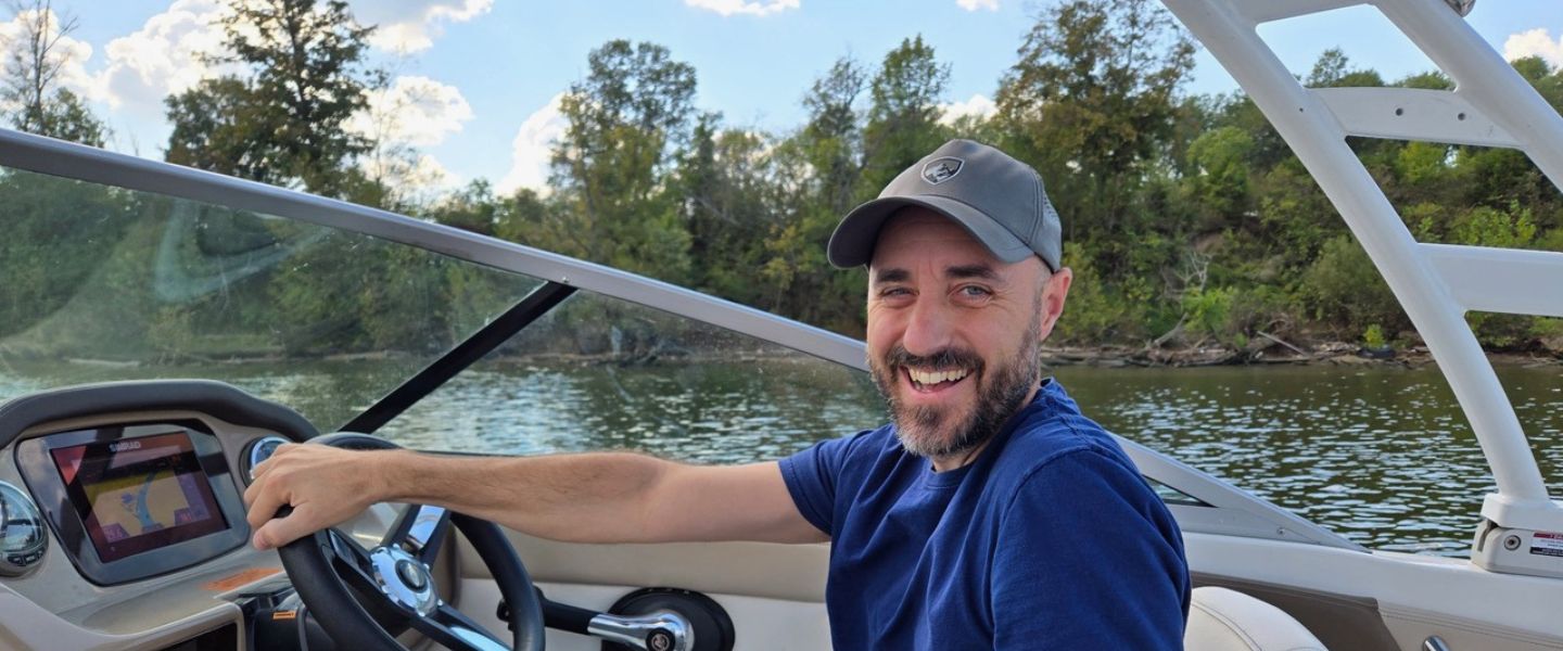 Dr. Matthew Heard on a boat during a research trip