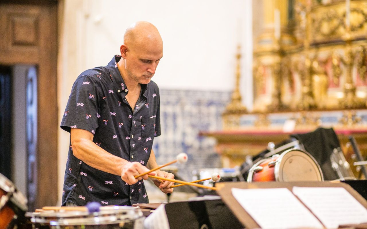 Dr. Christopher Fashun plays a percussion instrument