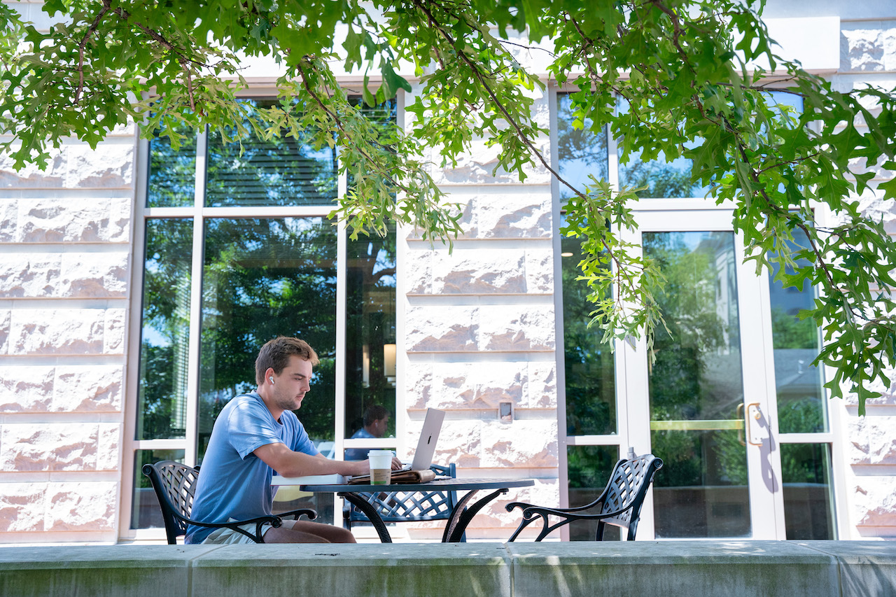 Student on laptop outside side