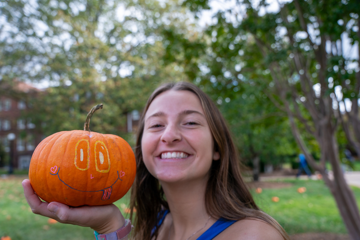 Student with painted pumpkin