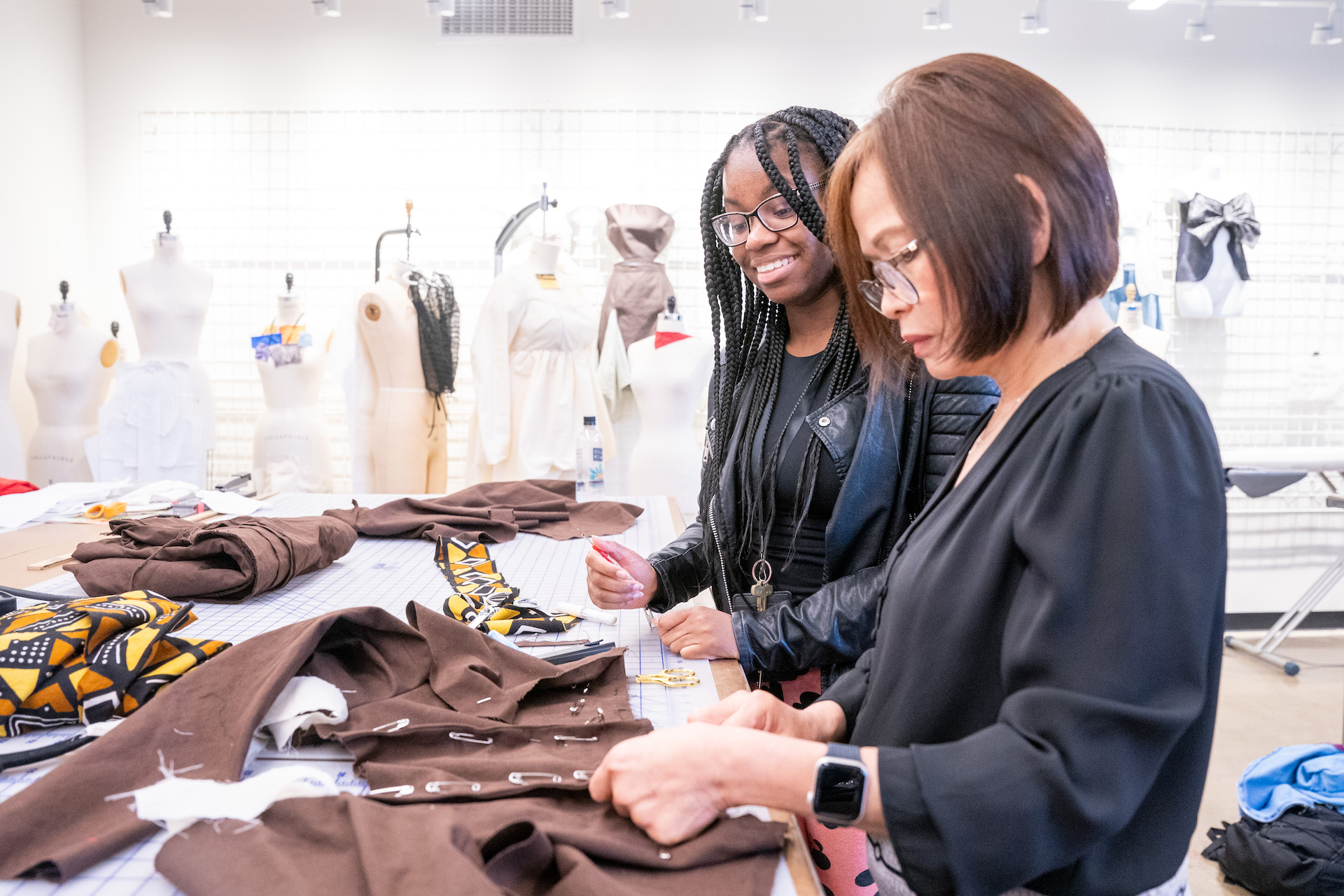 Student and fashion faculty work side by side