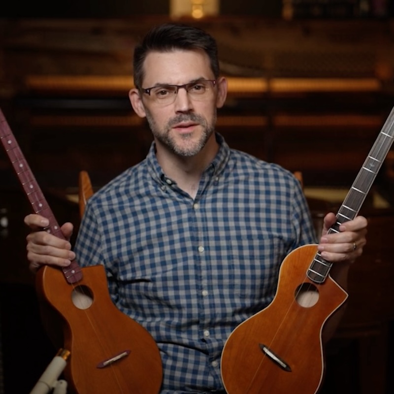 Ryan holding both versions of his instrument