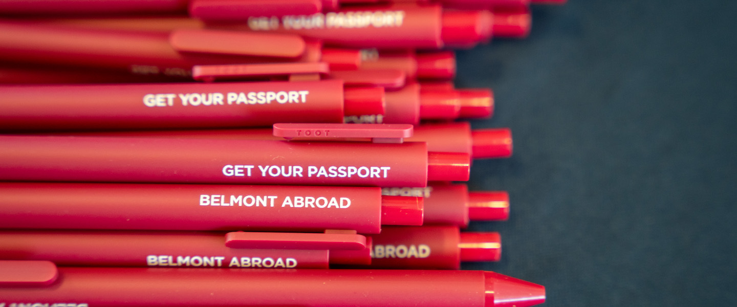 red Belmont abroad pens that say "get your passport"